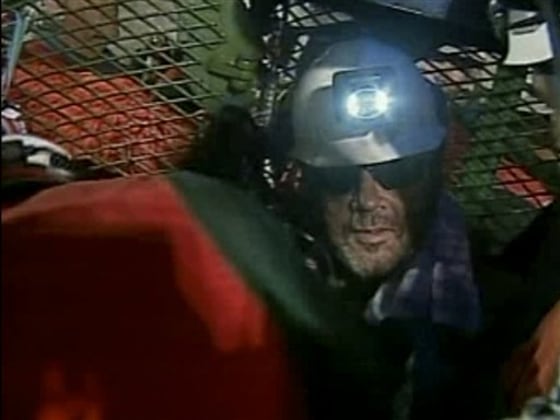 In this screen grab taken from video, Luis Urzua, center, the 33rd and final miner to be rescued from the San Jose Mine near Copiapo, Chile, is seen after his rescue Wednesday, Oct. 13, 2010. (AP Photo)